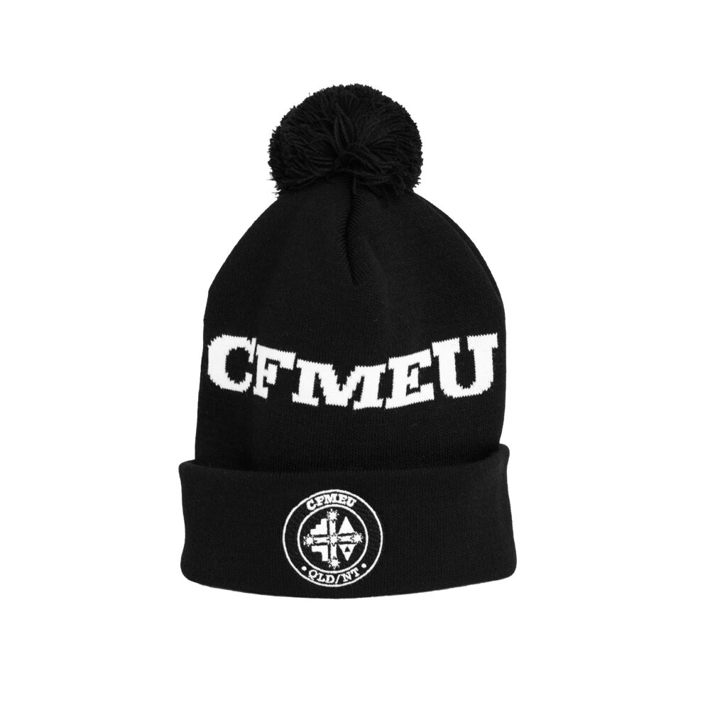 Black knit beanie with a pom-pom and white text around the cuff with a circular emblem on the front area of the hat cool graphic detail