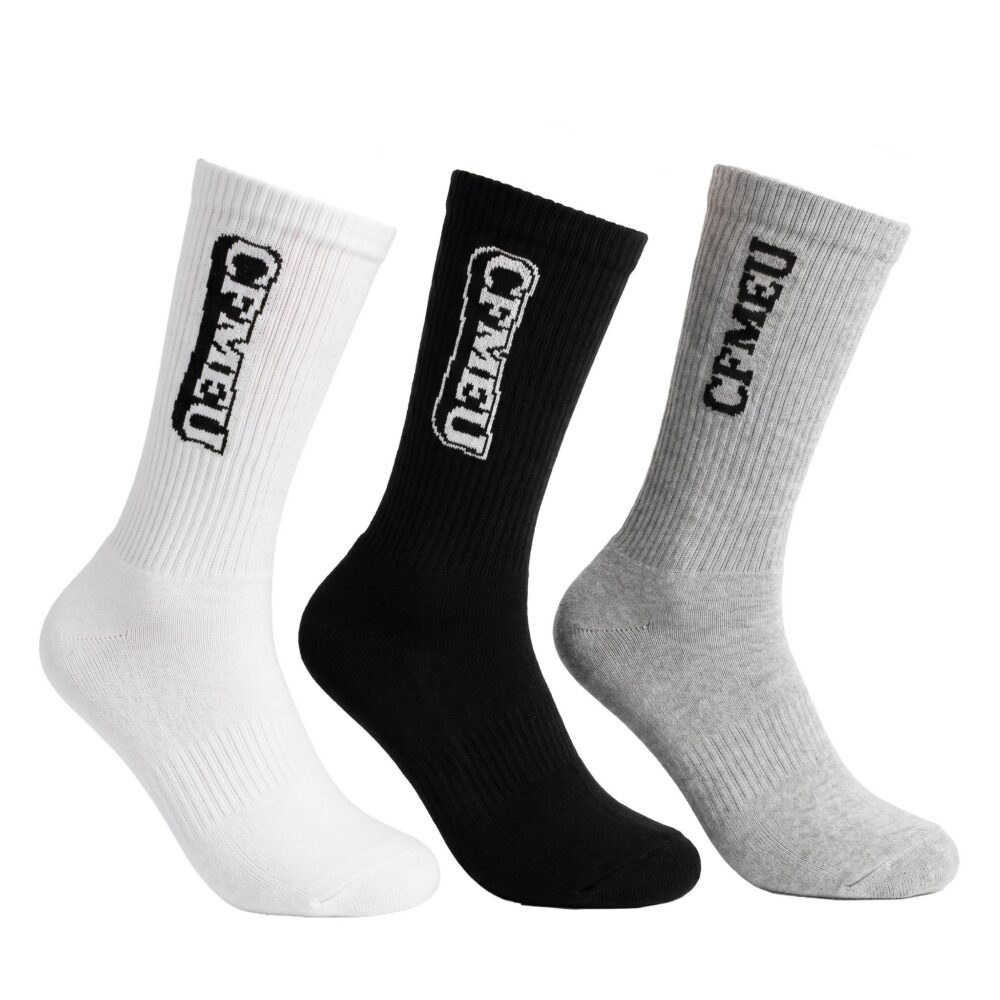 Three knee-length socks in white, black, and gray arranged diagonally with ribbed texture and visible branding along the side edge.