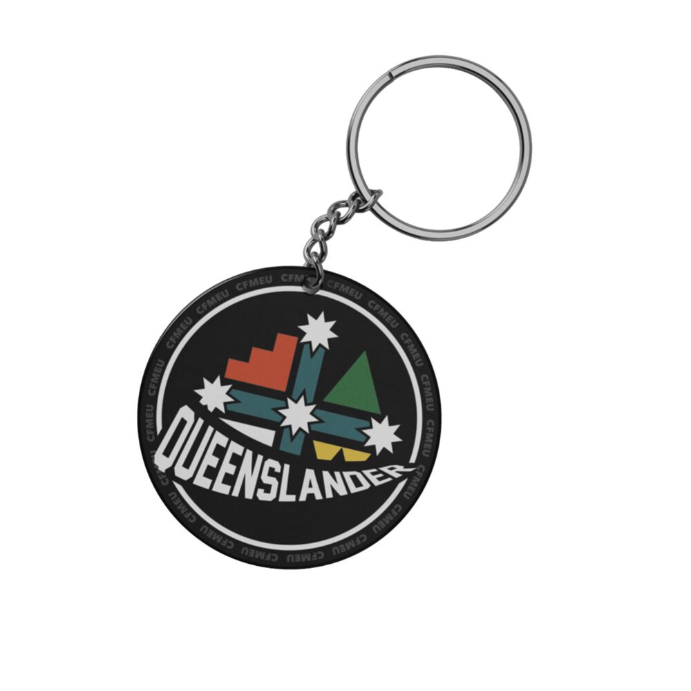Circular black keychain with a metal ring; pendant features a colorful mountain and star graphic with 'QUEENSLANDERS' text around the edge