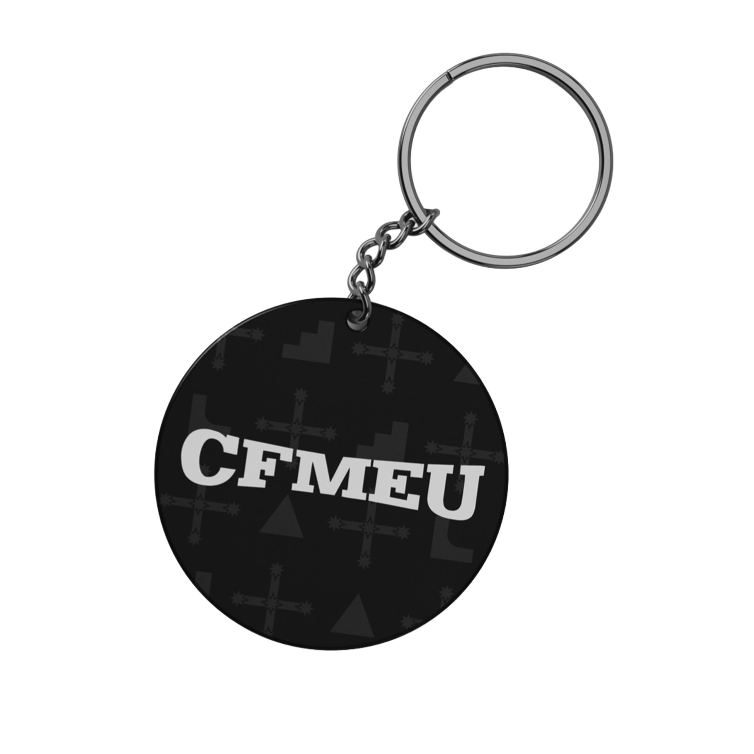 Close-up of a silver keyring attached to a black circular pendant with the word 'CEMENT' in white letters.