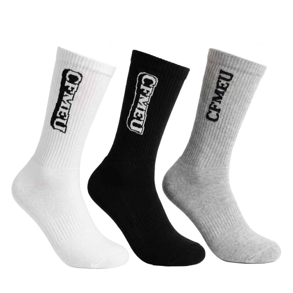 Three crew socks in white, black, and gray arranged diagonally from lower left to upper right, ribbed texture visible.